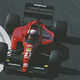 A photo of the 1991 Ferrari Formula 1 car driving round a corner.